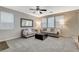 Bright living room featuring dual sofas, black ottoman, and neutral color palette at 7042 Grand Junction Ave, Las Vegas, NV 89179