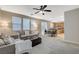 Open living room, kitchen, and dining area with ample natural light at 7042 Grand Junction Ave, Las Vegas, NV 89179