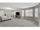Spacious main bedroom with neutral colors, carpet, and large windows allowing ample natural light at 7042 Grand Junction Ave, Las Vegas, NV 89179