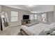 Neutral color scheme in main bedroom with plush carpet, large windows, and media center at 7042 Grand Junction Ave, Las Vegas, NV 89179