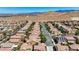Street view of a residential neighborhood featuring well-maintained homes with desert landscaping and mountain views at 7042 Grand Junction Ave, Las Vegas, NV 89179