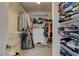 Walk-in closet with built-in shelving and ample space for clothing and storage at 7042 Grand Junction Ave, Las Vegas, NV 89179