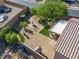 An aerial shot reveals a well-maintained backyard with mature trees, water feature, landscaping, and covered patio at 711 Golden Sedum Dr, Henderson, NV 89011