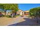 This backyard features gravel landscaping, a water fountain and a covered patio with an awning for relaxing at 711 Golden Sedum Dr, Henderson, NV 89011