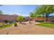 Backyard with desert landscaping, artificial grass and fountain at 711 Golden Sedum Dr, Henderson, NV 89011