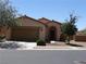 Inviting single-story house featuring a two-car garage and desert-style landscaping at 711 Golden Sedum Dr, Henderson, NV 89011