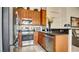 Well-equipped kitchen with stainless steel appliances, granite countertops, and wooden cabinets at 711 Golden Sedum Dr, Henderson, NV 89011