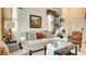 A bright living room featuring a comfortable couch, tasteful decor, natural light, and a cozy ambiance at 711 Golden Sedum Dr, Henderson, NV 89011