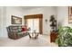 Relaxing living room with a comfortable leather sofa, a coffee table, and a view of the backyard at 711 Golden Sedum Dr, Henderson, NV 89011
