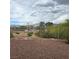 Desert landscaping with metal fence and mountain views in the background at 7152 Fairwind Acres Pl, Las Vegas, NV 89131