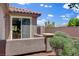 An exterior view of the back patio of the home showcases the landscaping and outdoor space at 7152 Fairwind Acres Pl, Las Vegas, NV 89131