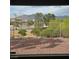 A backyard view from inside the home showcases the desert landscaping and mountain views at 7152 Fairwind Acres Pl, Las Vegas, NV 89131