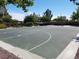 Community basketball court is surrounded by lush trees and is a great place for residents to gather and play at 7152 Fairwind Acres Pl, Las Vegas, NV 89131