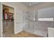 Modern bathroom featuring a glass enclosed shower with marble tile and a separate walk in closet at 7152 Fairwind Acres Pl, Las Vegas, NV 89131