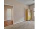 Bedroom with neutral carpeting, a light-wood armoire, and a view to the hall at 7152 Fairwind Acres Pl, Las Vegas, NV 89131