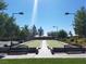 Outdoor bocce ball court with benches and lighting provides a recreational amenity for residents in a landscaped green space at 7152 Fairwind Acres Pl, Las Vegas, NV 89131