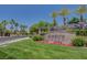 Elegant community entrance features lush landscaping and decorative signage, conveying a sense of prestige at 7152 Fairwind Acres Pl, Las Vegas, NV 89131