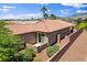 A well-kept home features desert landscaping, a red tile roof and a private patio area at 7152 Fairwind Acres Pl, Las Vegas, NV 89131