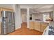 Open kitchen with stainless steel appliances and wood cabinetry, seamlessly connecting to the living area at 7152 Fairwind Acres Pl, Las Vegas, NV 89131
