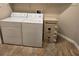Laundry area featuring washer, dryer, and safe on a diagonally tiled floor at 7152 Fairwind Acres Pl, Las Vegas, NV 89131