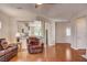Comfortable living room featuring hardwood floors and an open layout to the kitchen and dining area at 7152 Fairwind Acres Pl, Las Vegas, NV 89131