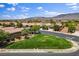Picturesque neighborhood street with lush lawns and mature trees, under a expansive blue sky at 7152 Fairwind Acres Pl, Las Vegas, NV 89131