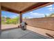 View of covered patio with BBQ grill and desert landscaping at 7152 Fairwind Acres Pl, Las Vegas, NV 89131