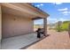 Covered patio area featuring a BBQ grill overlooking desert landscaping at 7152 Fairwind Acres Pl, Las Vegas, NV 89131