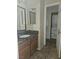 Bathroom with a single vanity, granite countertop, and a washer and dryer in the background at 7300 Pirates Cove Rd # 2025, Las Vegas, NV 89145