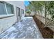 This backyard has a concrete patio area, windows and doors into the home, and a tree-lined border at 7319 Burnt Umber St, Las Vegas, NV 89139