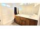 Bathroom with a double sink vanity, shower/tub combo, and neutral color scheme at 7319 Burnt Umber St, Las Vegas, NV 89139