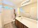 Functional bathroom with a tub-shower combo, decorative shower curtain, and a vanity with a mirror at 7319 Burnt Umber St, Las Vegas, NV 89139