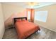 Inviting bedroom with large window, ceiling fan and mountain-themed color block wall at 7319 Burnt Umber St, Las Vegas, NV 89139