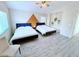 Spacious bedroom featuring two queen beds, modern décor, and ceiling fan, creating a restful retreat at 7319 Burnt Umber St, Las Vegas, NV 89139