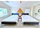 Bright bedroom featuring two queen beds, decorative accent wall, and ample natural light at 7319 Burnt Umber St, Las Vegas, NV 89139