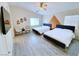Cozy bedroom with two beds, accent wall, and ample natural light, perfect for guests or children at 7319 Burnt Umber St, Las Vegas, NV 89139