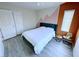 This bedroom features gray wood-look floors, a bed with a blue headboard, and three doors at 7319 Burnt Umber St, Las Vegas, NV 89139