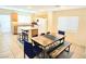 Open dining area with seating and view to the island and kitchen at 7319 Burnt Umber St, Las Vegas, NV 89139