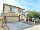 Beautiful two-story home featuring a two-car garage, stone accents, and neat landscaping at 7319 Burnt Umber St, Las Vegas, NV 89139