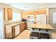Modern kitchen with island seating, wooden cabinets and stainless steel appliances at 7319 Burnt Umber St, Las Vegas, NV 89139