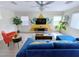 Bright living room with a blue sofa, large windows, and an open layout, great for entertaining at 7319 Burnt Umber St, Las Vegas, NV 89139