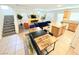 Bright, open-concept living room featuring modern decor and a dining area with a wooden table at 7319 Burnt Umber St, Las Vegas, NV 89139