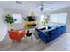Stylish living room featuring a modern blue sofa, orange chair, and decorative accent wall at 7319 Burnt Umber St, Las Vegas, NV 89139