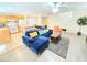 Open-concept living area with modern furnishings, breakfast bar and view of staircase and dining area at 7319 Burnt Umber St, Las Vegas, NV 89139
