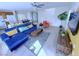 Open-concept living room with a blue sectional, entertainment center, and adjacent kitchen at 7319 Burnt Umber St, Las Vegas, NV 89139