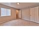 This bedroom includes neutral paint, tile flooring, natural light, and ample closet space at 7885 W Flamingo Rd # 1016, Las Vegas, NV 89147