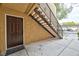 Entryway featuring a brown door with a staircase leading up to the units, designed with functional access in mind at 7885 W Flamingo Rd # 1016, Las Vegas, NV 89147