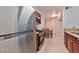 Charming kitchen with stainless steel appliances, tile floors, wood cabinets, and an adjacent dining area at 7885 W Flamingo Rd # 1016, Las Vegas, NV 89147