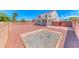 Expansive backyard showcasing gravel and a brick firepit, ideal for gatherings and outdoor enjoyment at 7892 Villa Salsa Ave, Las Vegas, NV 89131