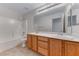 Bathroom featuring a double sink vanity, large mirror, and a shower-tub combo, for both comfort and functionality at 7892 Villa Salsa Ave, Las Vegas, NV 89131